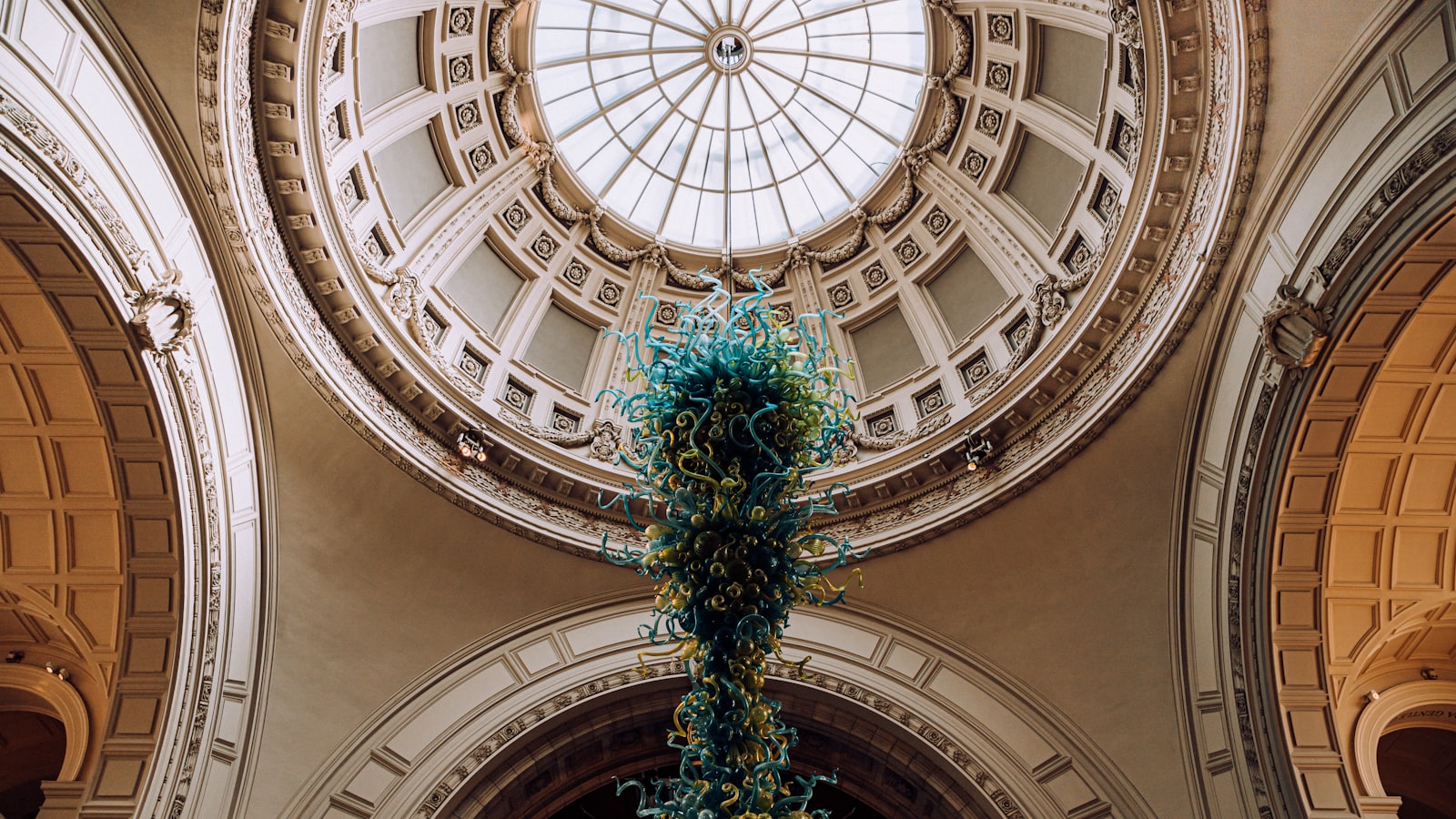 Domed museum ceiling with a glass chandelier, echoing the V&A rotunda that hosts the Global Design Forum