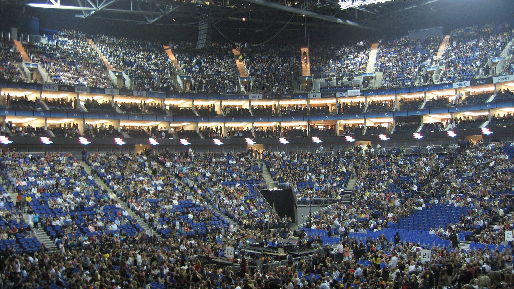 Interior of The O2 arena in London filling up before a concert, with tiered seating and the floor section visible