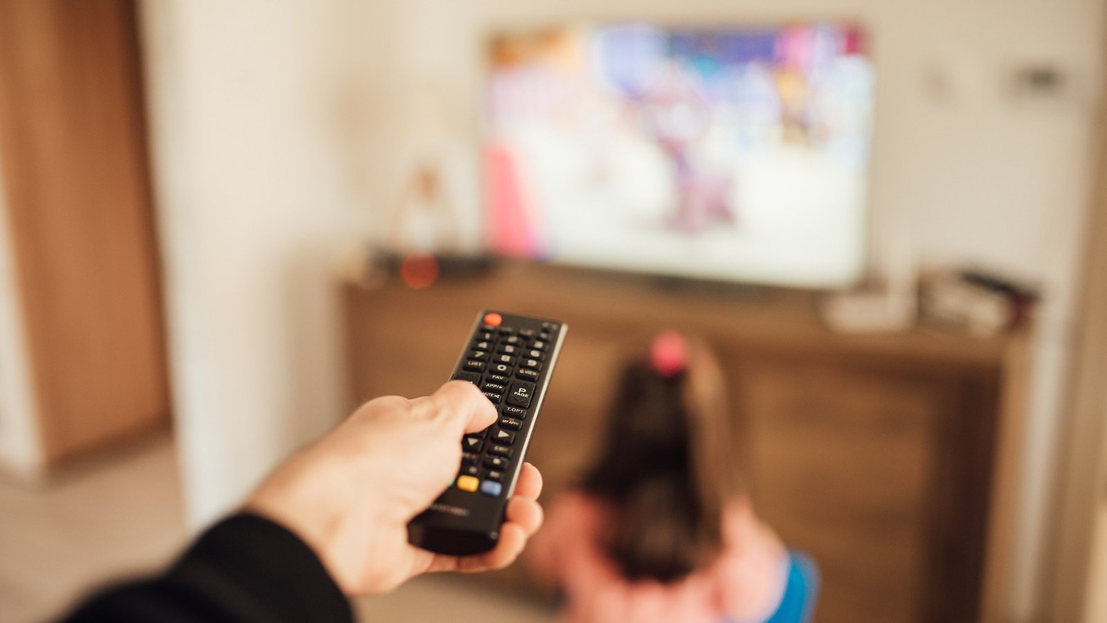 A parent with a remote control and a child watching a television, weekly viewing habits that keep Nigella Lawson Bake Off on Tuesday nights
