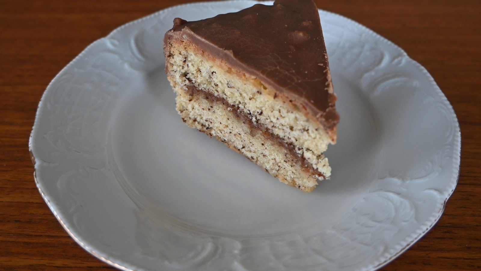 A slice of chocolate cake on a white plate, the sort of bake Nigella Lawson judges on Bake Off