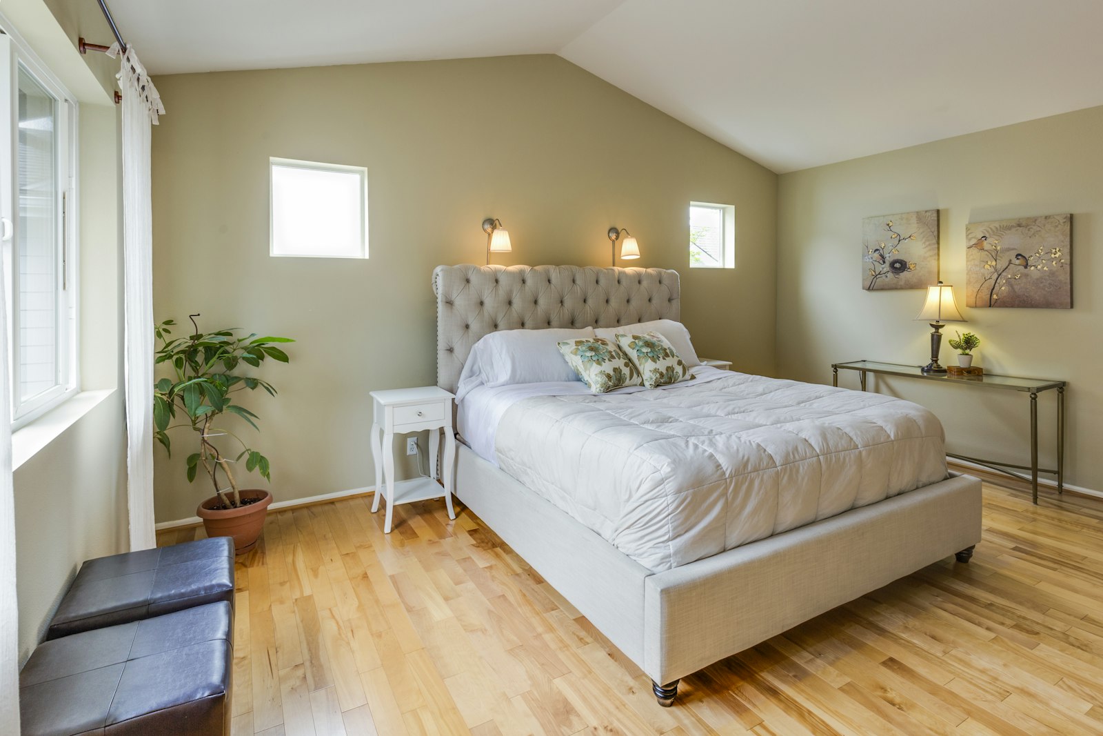 Small bedroom with a light upholstered bed and pale headboard, an example of oversized headboard ideas that suit compact rooms