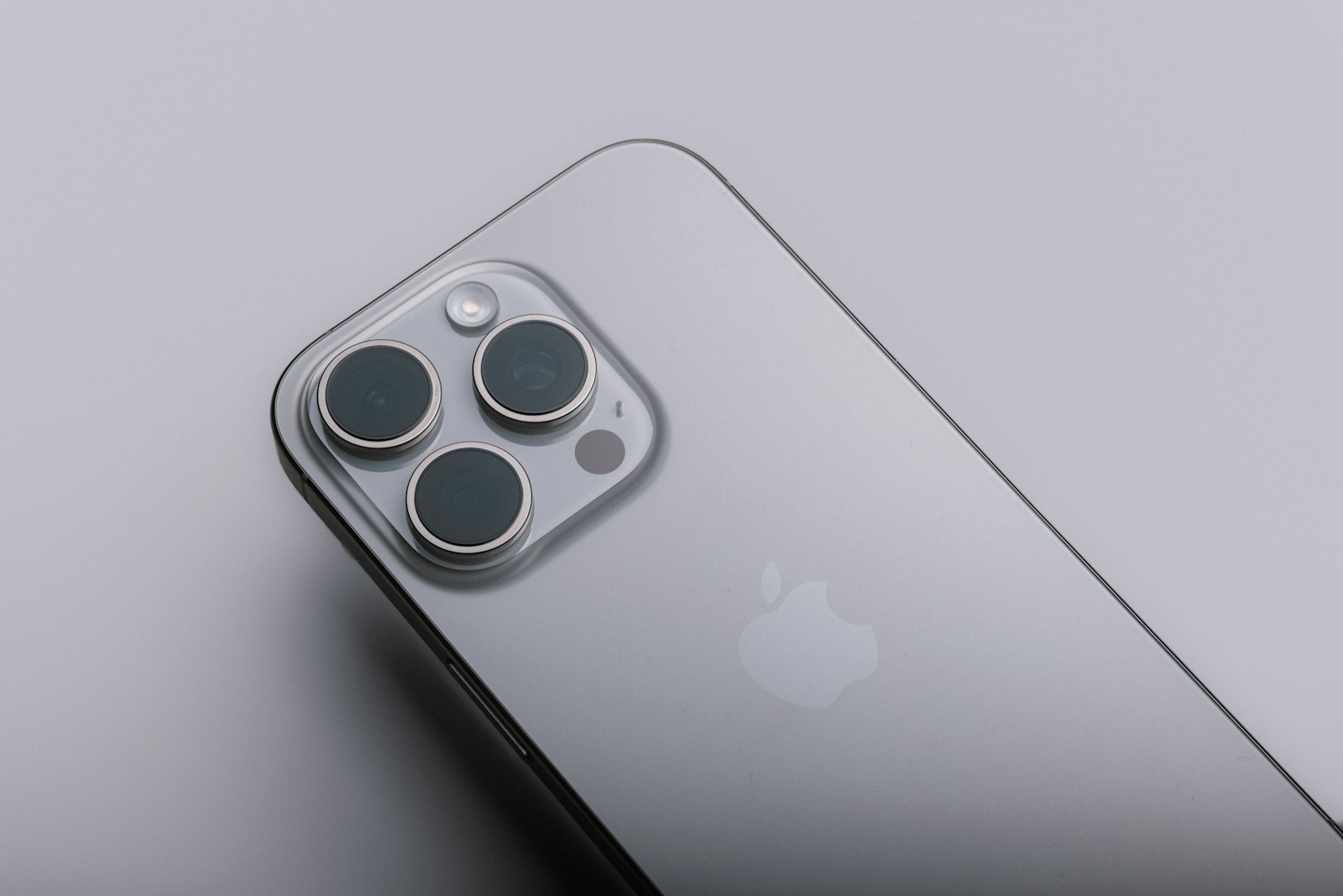 Close-up of a refurbished iPhone camera module on a grey background