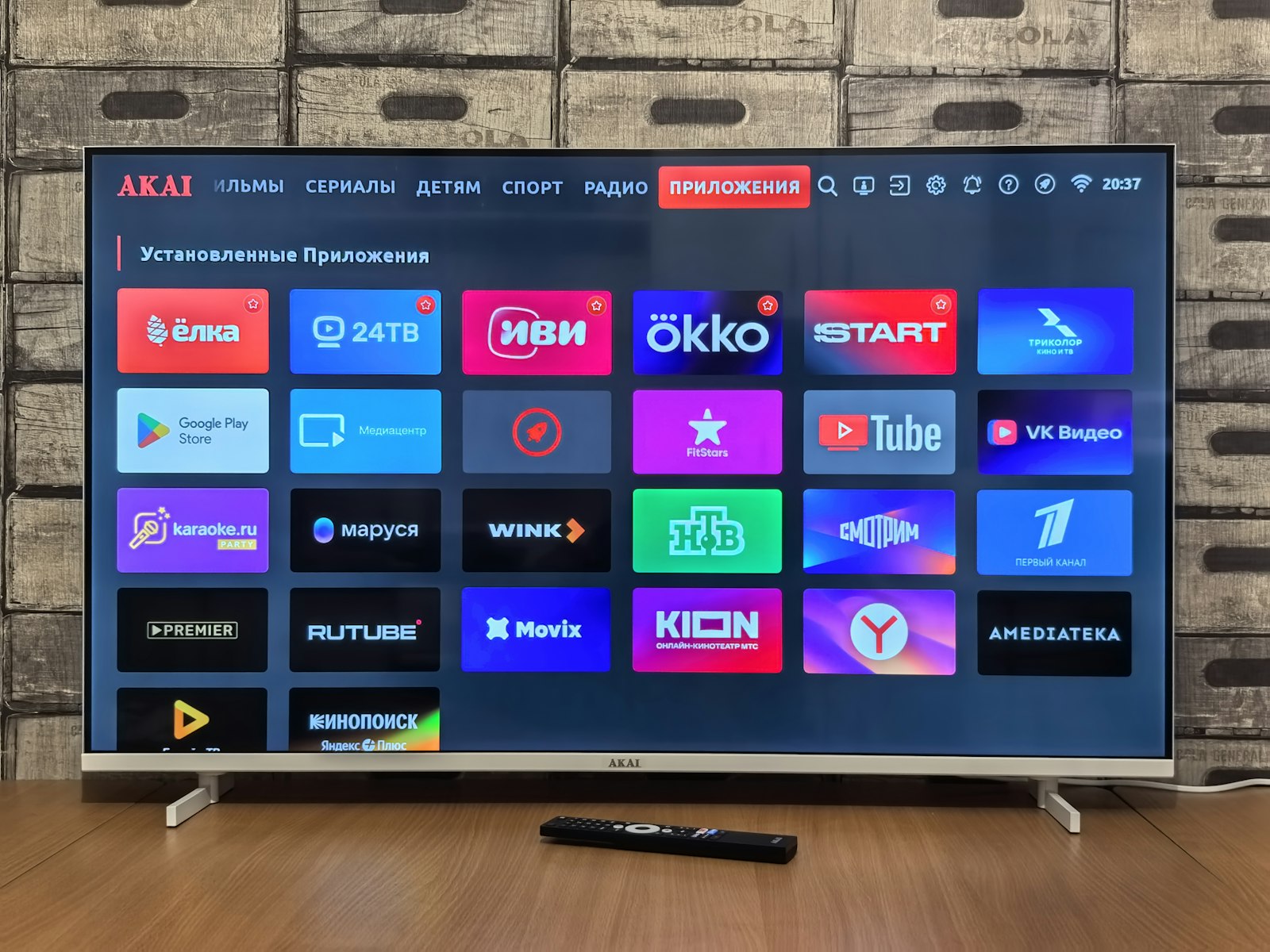 Smart TV home screen showing rows of streaming app icons in a darkened living room