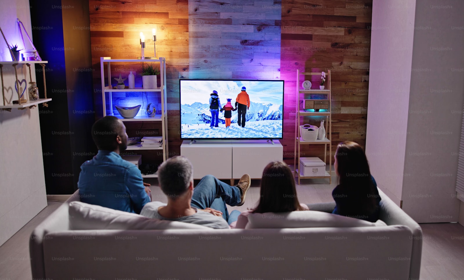 Family watching a film together on the living room television