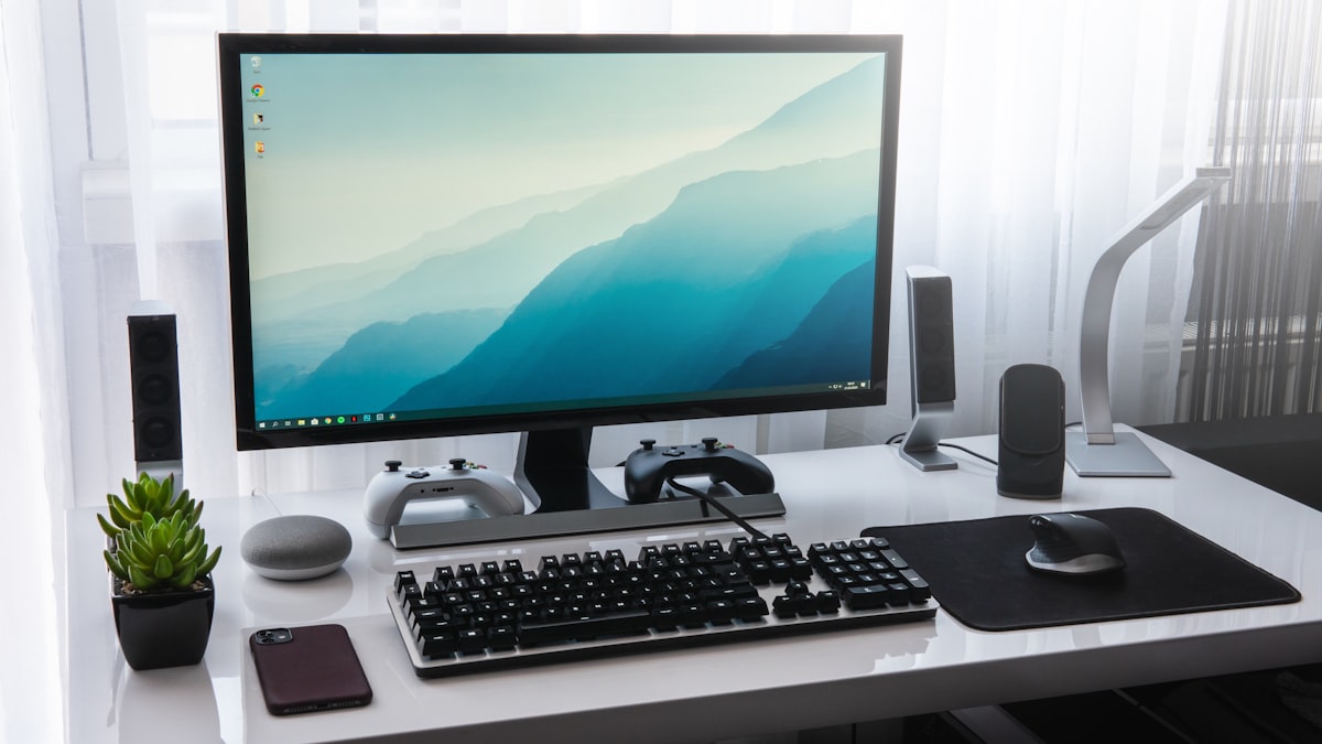 A single 27-inch monitor on a tidy white home office desk