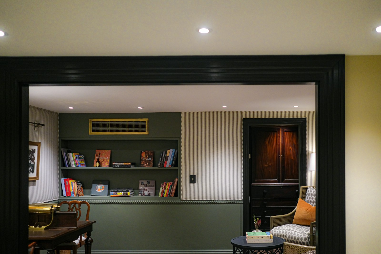 A compact reading corner with an armchair and bookshelf, the size a snug should be