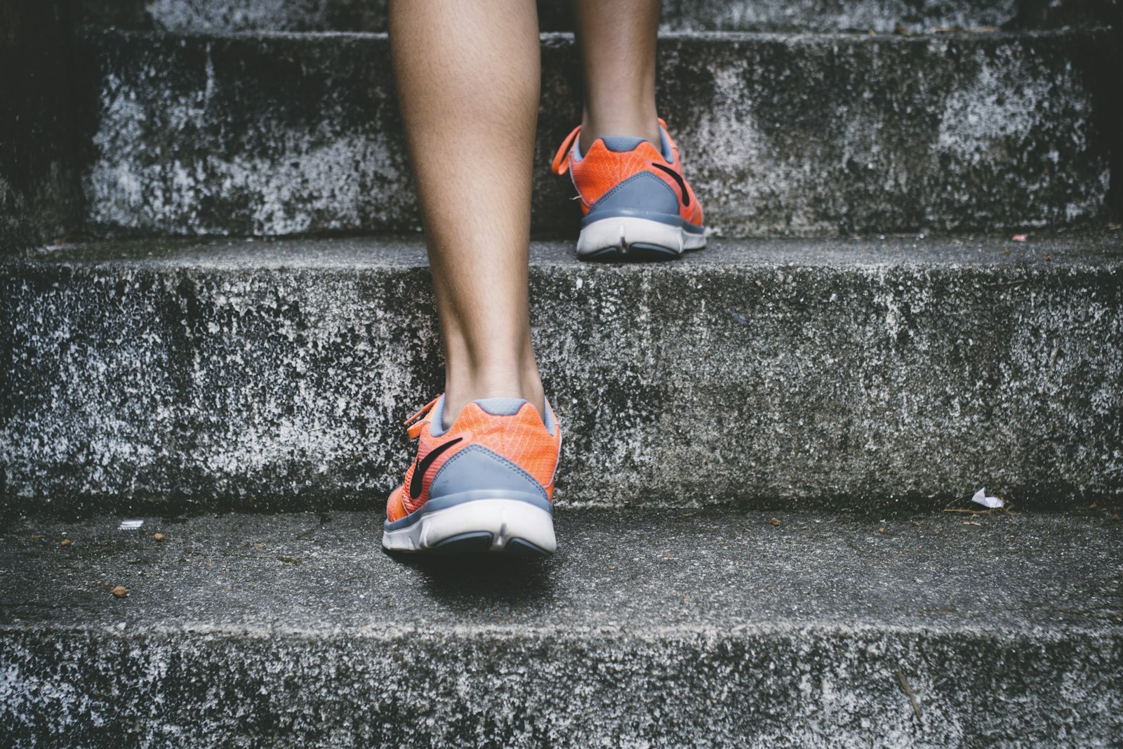 Trainers on concrete steps, the kind of stair work that loads bone harder than flat walking