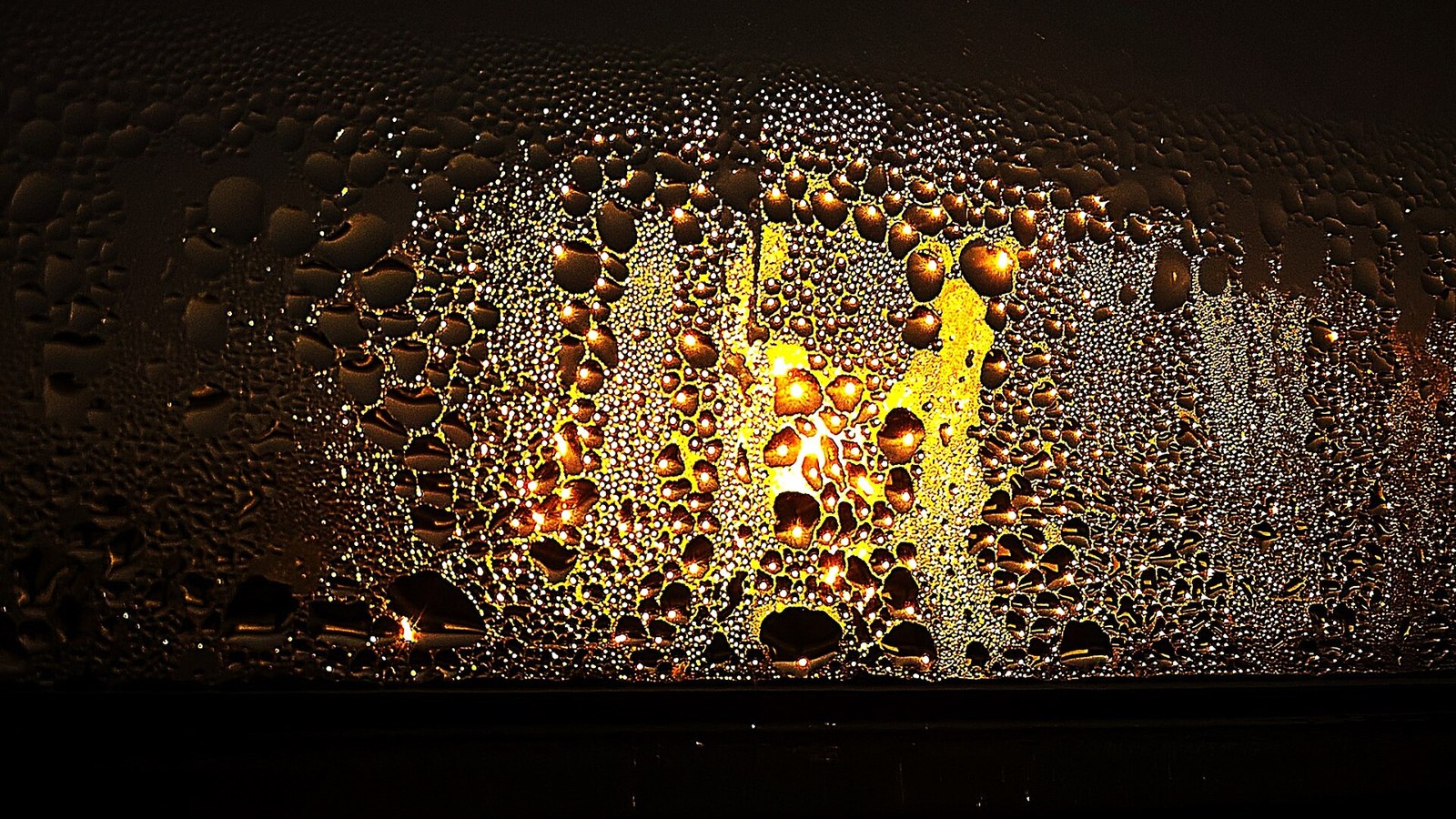 Condensation on a window at sunset, a sign the room needs a dehumidifier