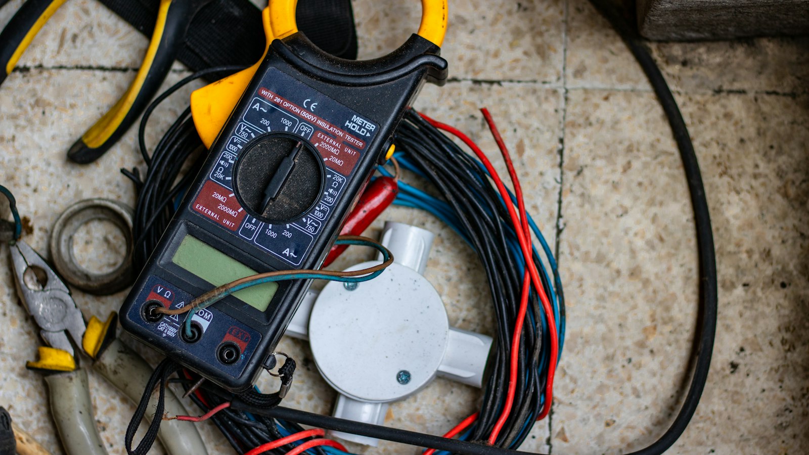 A clamp meter and electrical tools, the kind of kit an energy monitor replaces