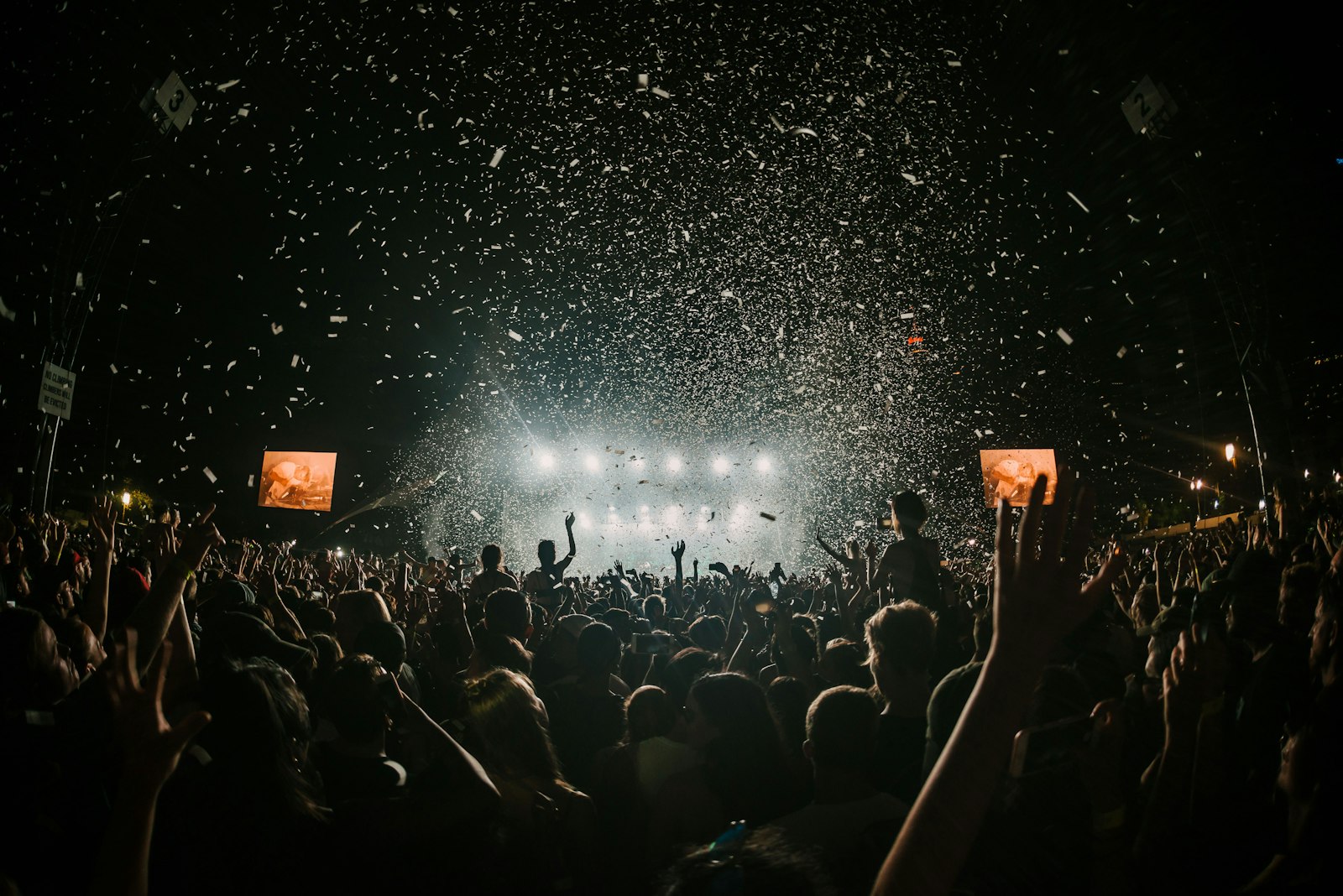 Confetti falling over a packed audience in the dark, capturing the crush that makes the Frieze London 2026 preview-day ticket tempting