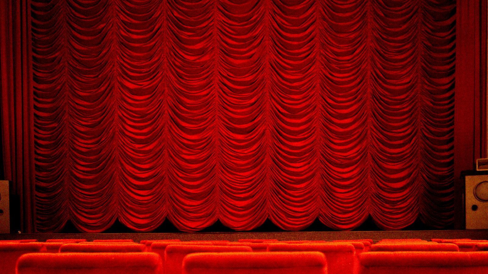 Red theatre curtain and seats, the kind of big screen setting for The Devils and Corman's Poe films