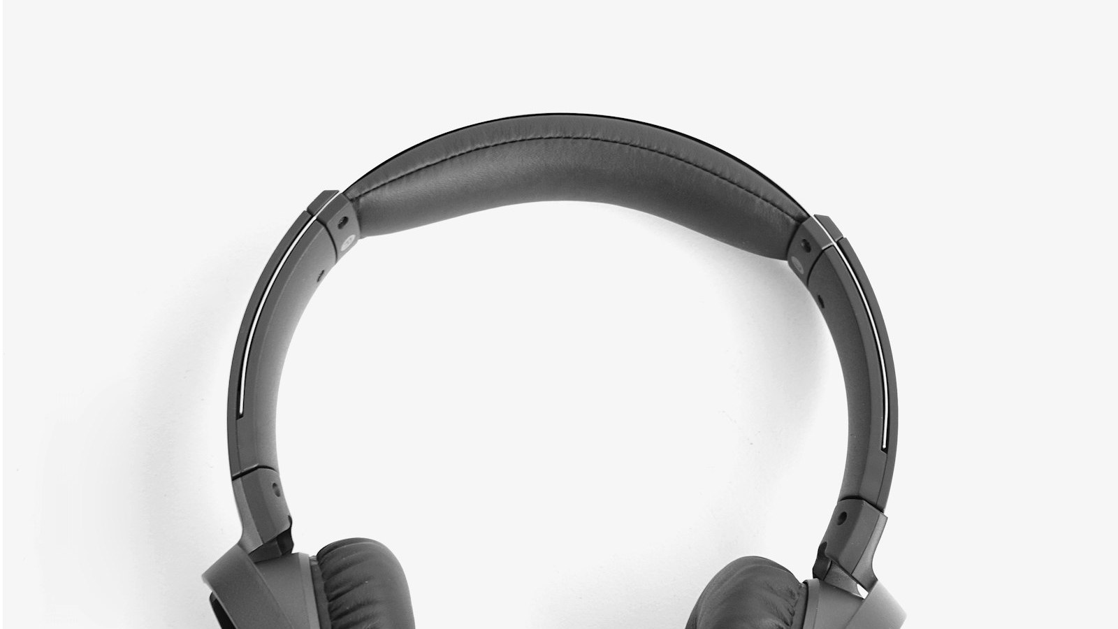 Grey wired over-ear headphones with a flat cable, a budget pair that keeps bus audio private