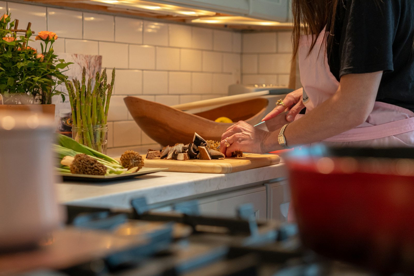 Woman chopping vegetables on a cutting board in a home kitchen, preparing a meal after a fast