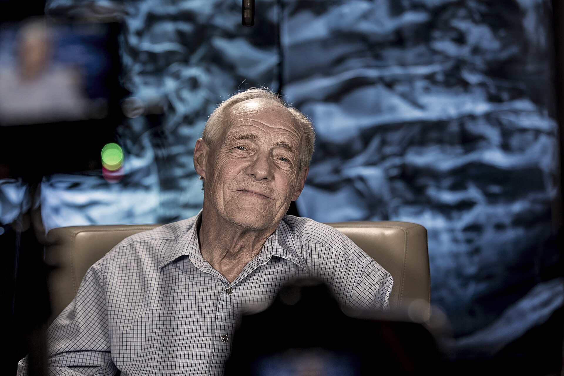 Person sitting in front of a television set, representing Sunday night drama viewing