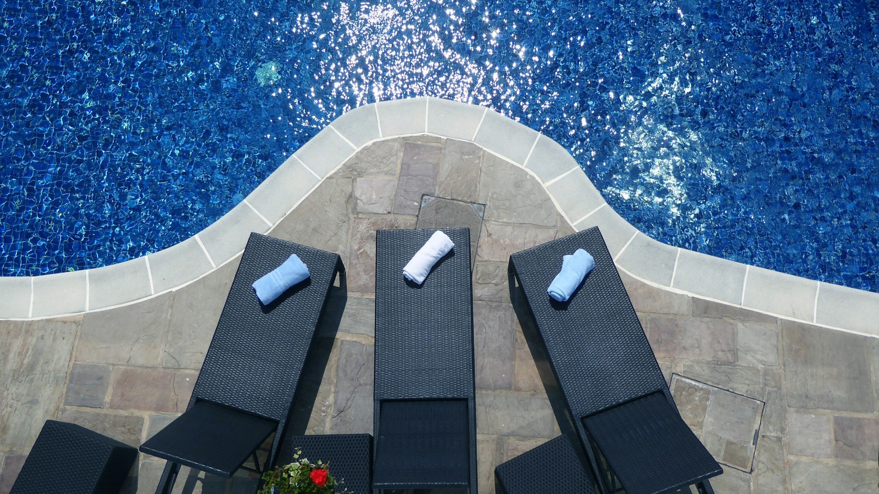 Sun loungers beside a blue hotel pool, the kind of winter sun holidays under £600 are built around